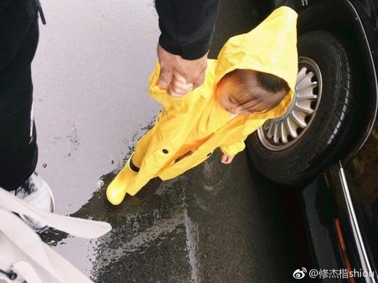 修杰楷晒女儿咘咘雨衣照  大眼睛冲天辫萌态十足！