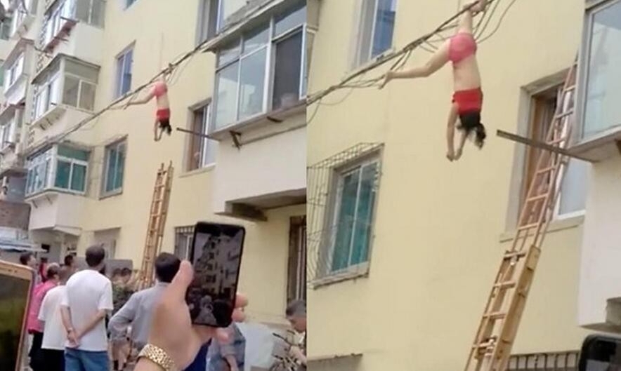 穿内衣倒挂电线杆
